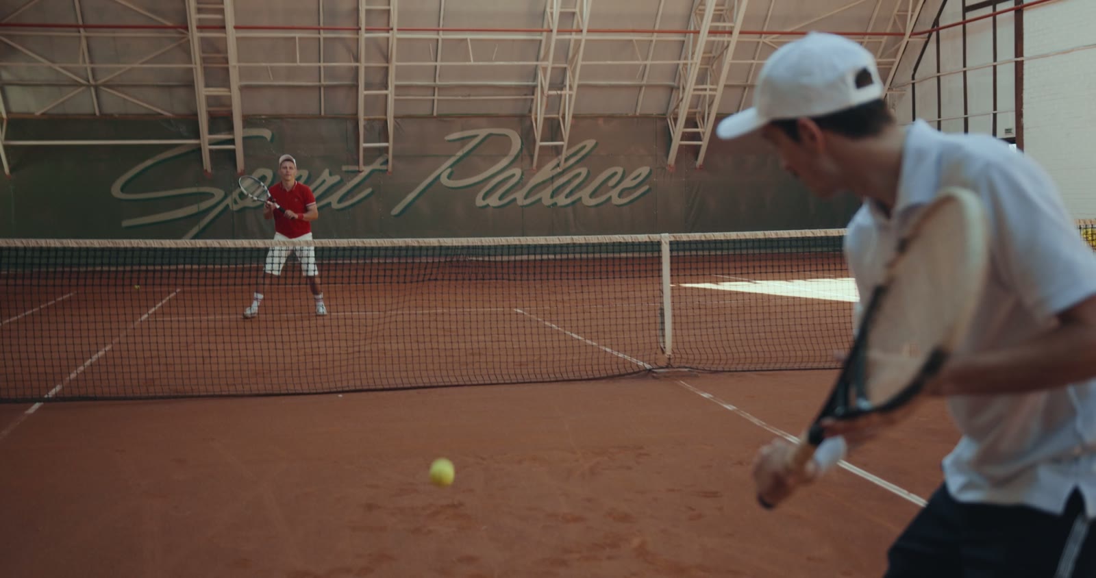 Tennis rally in motion on an outdoor court